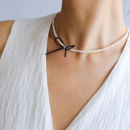 Korean all-match rice grain pearl black spike bow necklace female trend 925 silver freshwater pearl clavicle chain